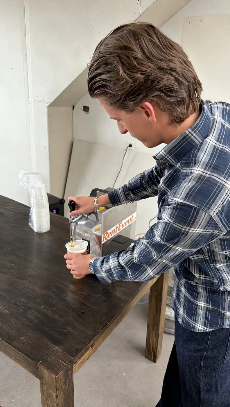RentEvent staff member pouring from the beer tap into a glass